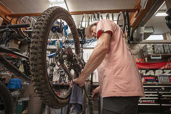 Jans Bike Technician working on a mountain bike at Jans Park Ave location in Park City, Utah.