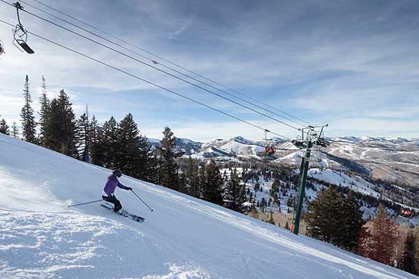 A skier skiing on a groomed run at Deer Valley Resort, Park City, Utah.
