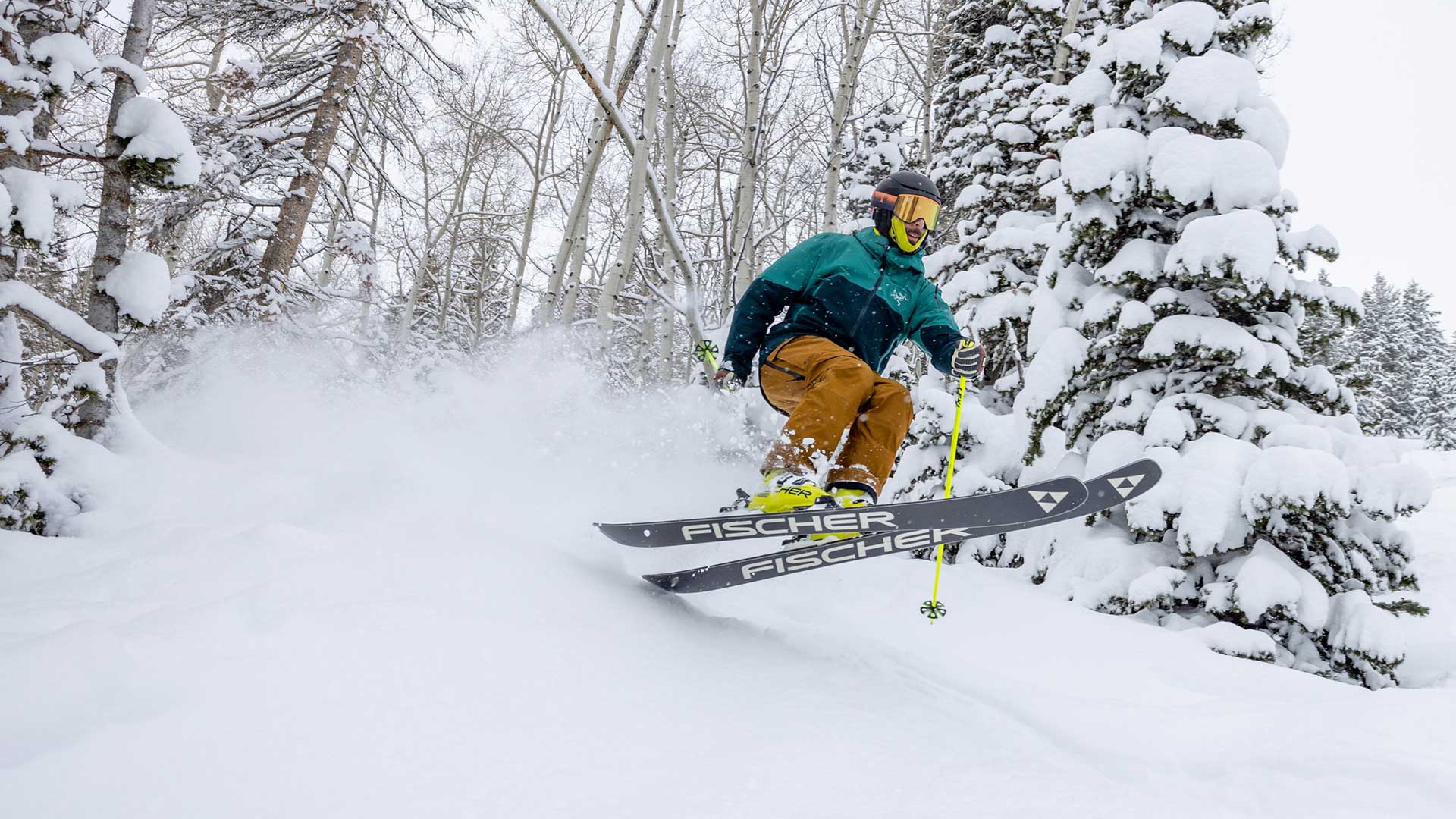 Person skiing in a snowy forest with a Fischer ski