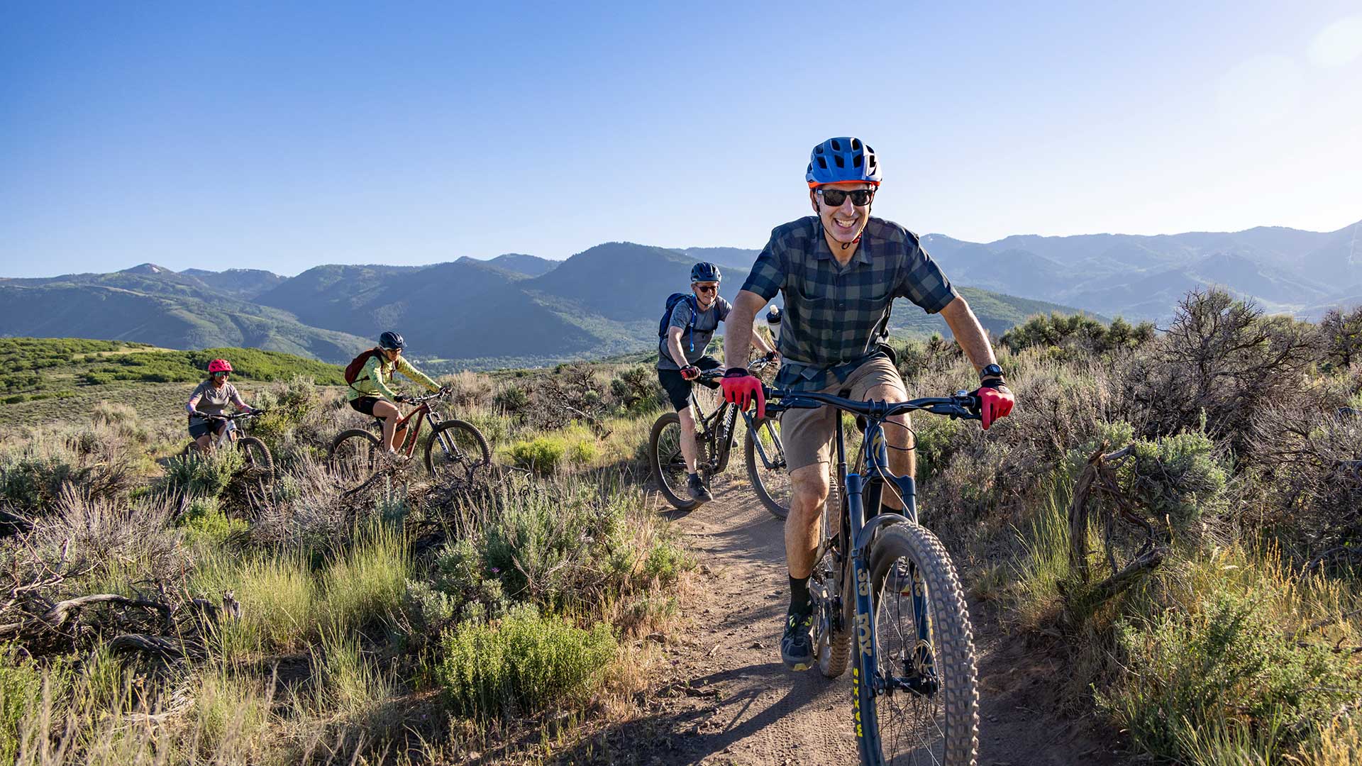 A group of people riding mountain bikes on a guided tour with Jans in Park City, Utah