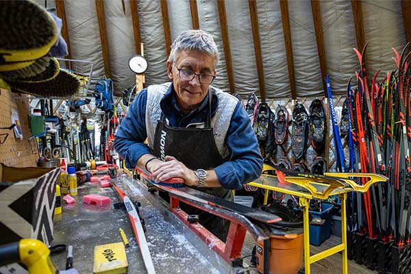 Ski technician tuning a cross country ski at the White Pine Nordic Center in Park City, Utah.