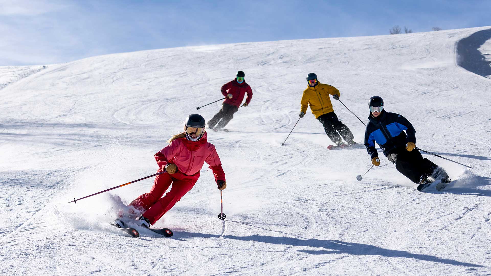 A group of 4 Jans Experts skiing on a groomed run at Deer Valley Resort, Park City, Ut. 