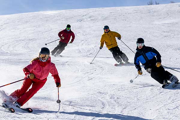 Jans Experts skiing together on a groomed run at Deer Valley Resort, Park City, Utah.