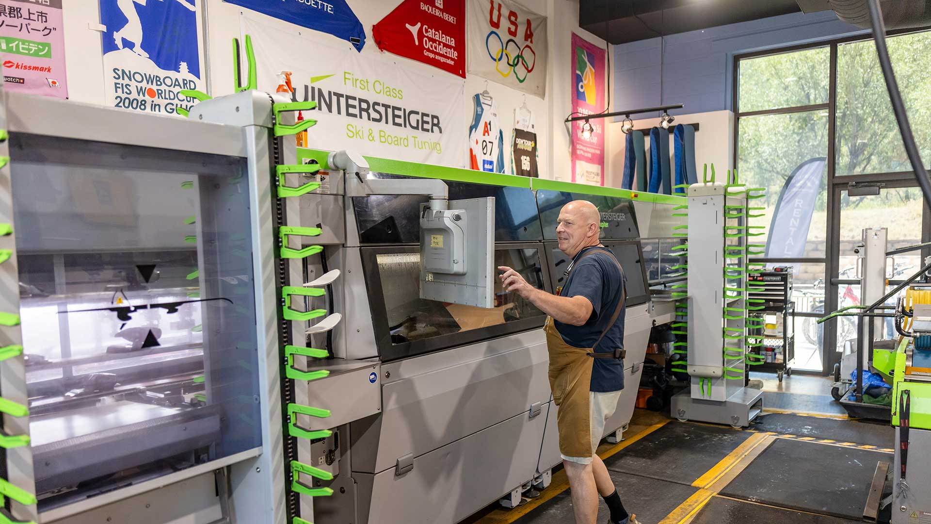 Rennstall manager, Andy Buckley tuning skis on the Winterstieger Jupiter machine at the Rennstall Tuning Center in Park City, Utah.