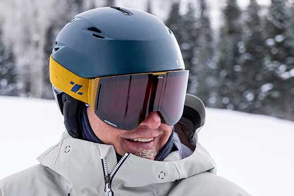 A close-up of Jans Expert, Jack Walzer, wearing a dark blue Giro ski helmet and yellow Zeal goggles while skiing at Deer Valley Resort, Park City, Utah.