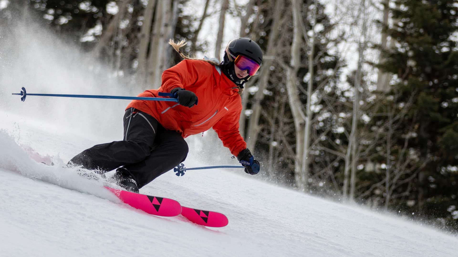 Jans Expert skiing on a groomed run with trees in the background in Park City, Utah.