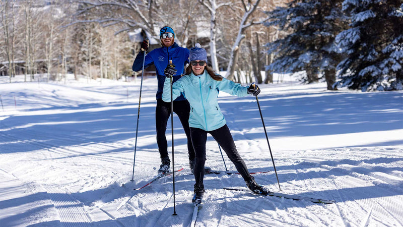Two individuals skate ski in Park City Utah. 