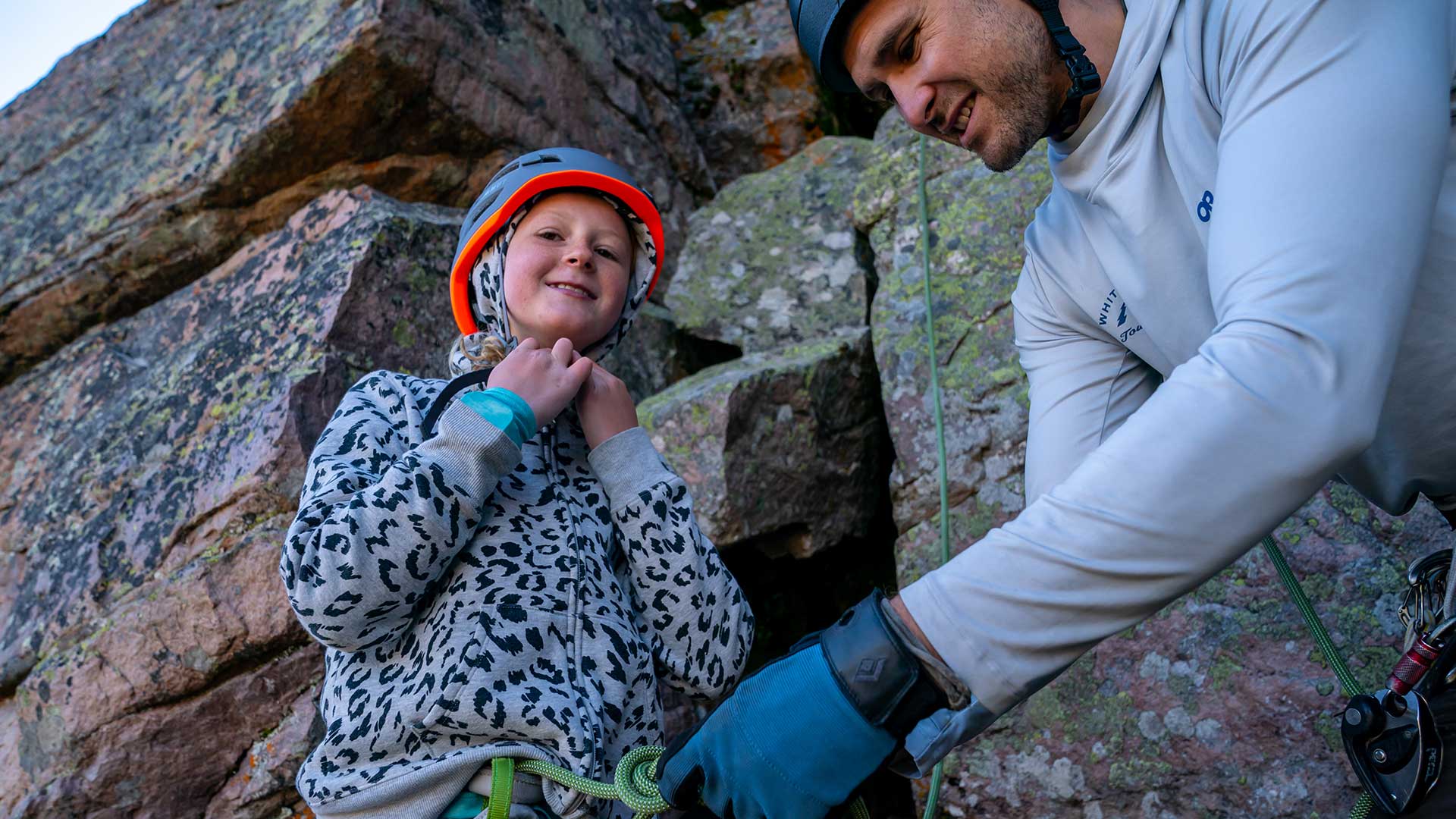 Jans Expert helping a child client tie into their harness during a guided rock climbing trip near Park City, Utah.