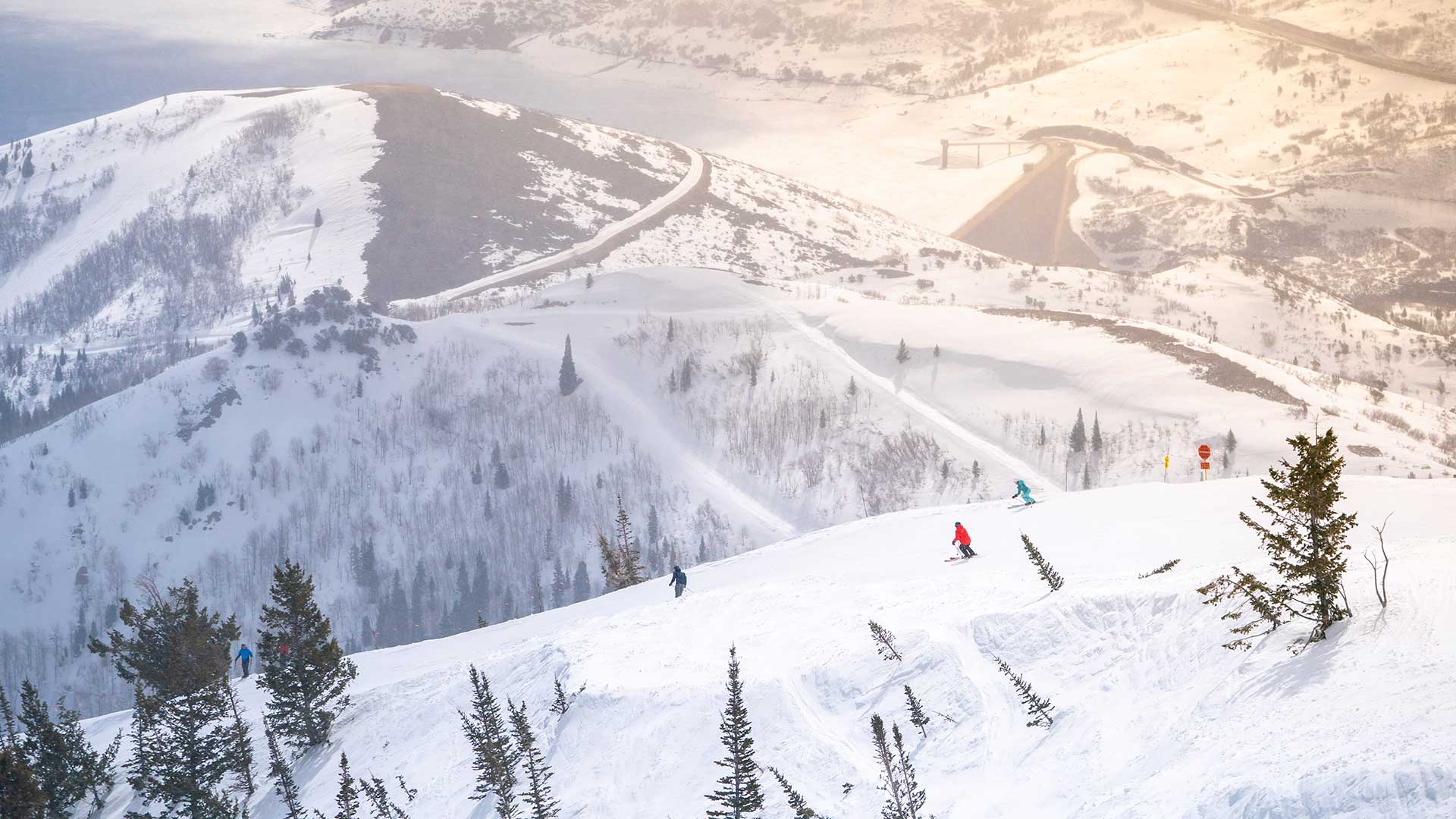 Snowy mountain landscape with skiers and a clear sky