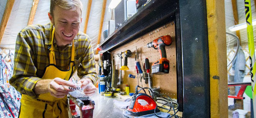 Man in a workshop with tools and equipment around