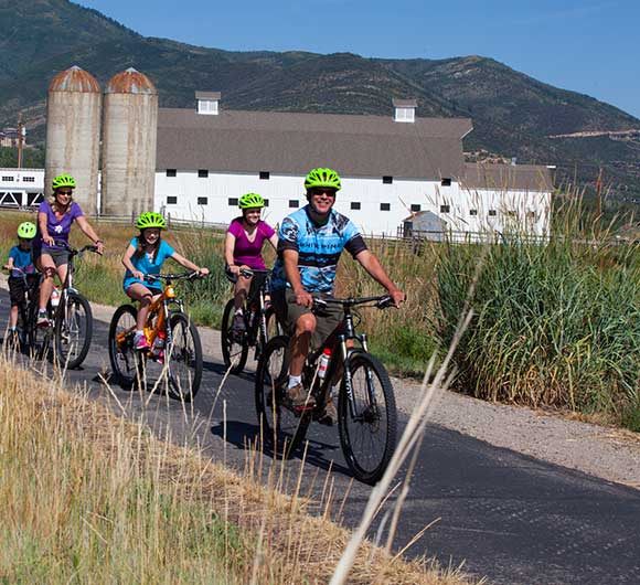 A family enjoys a guided pathway bike tour with Jans in Park City, Utah