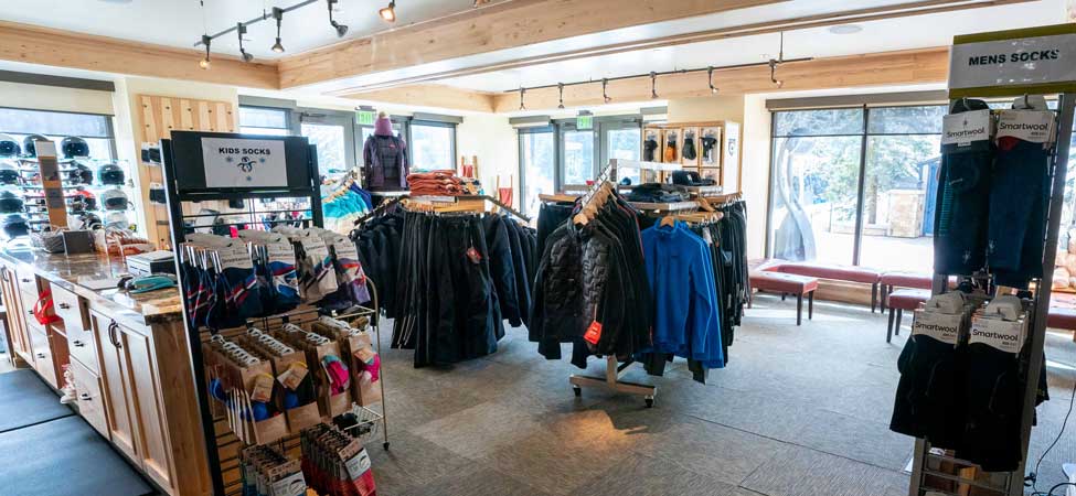 Interior of a store with clothing racks and displays.