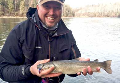Man holding a fish on a river